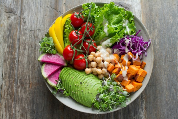 Colourful salad bowl on a wooden table
